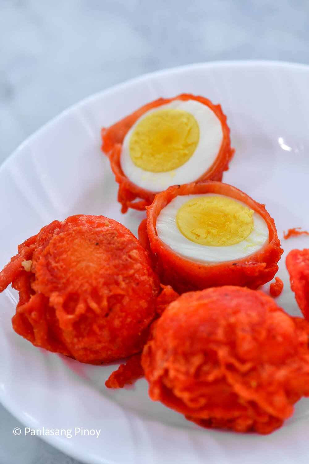 Halved crispy chicken egg on a plate