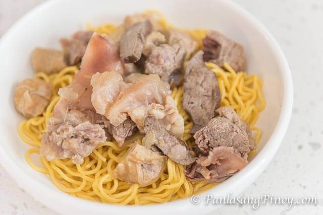 beef batchoy noodle soup with scallions and crunchy chicharon