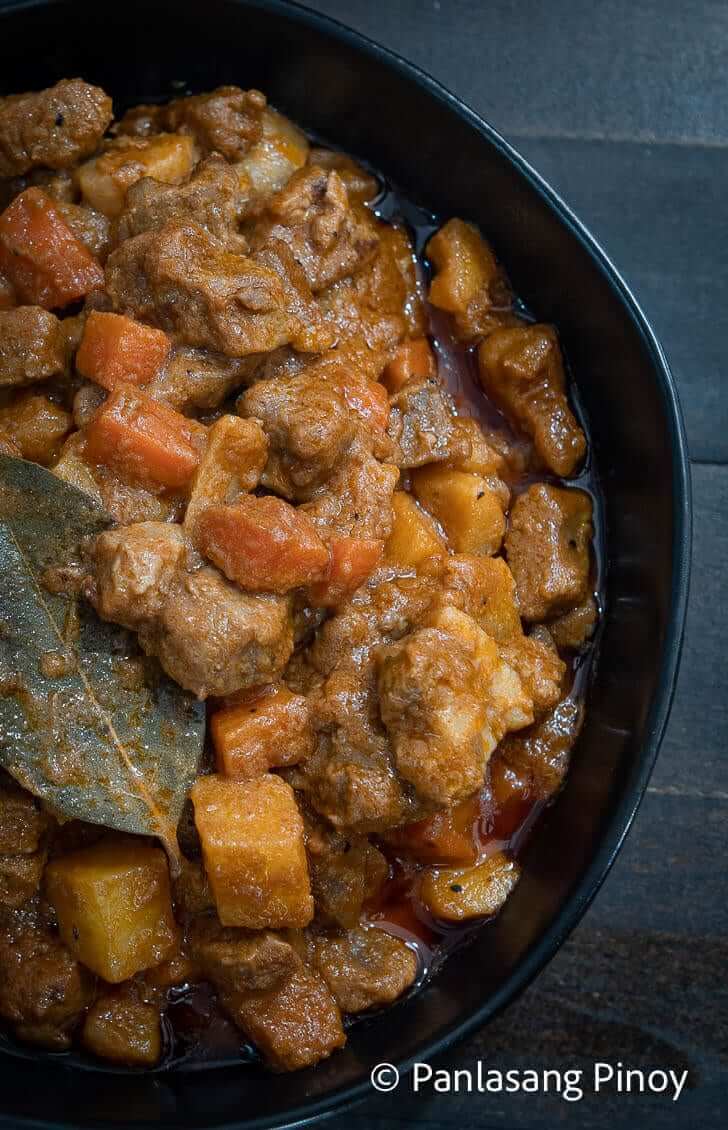 cooking pork menudo with coconut milk