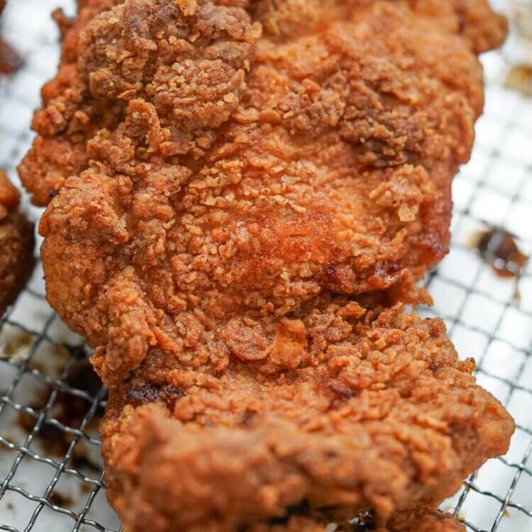 Crispy fried chicken thigh over a rack