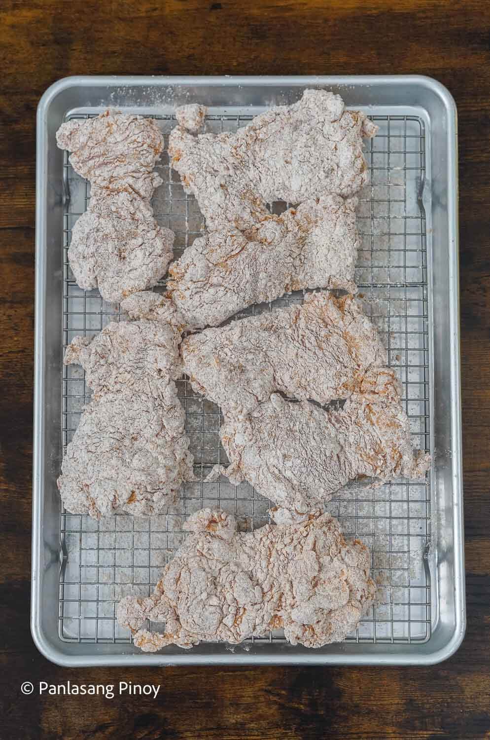 Coated chicken on a rack